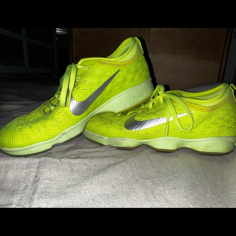 Bright neon green/yellow NIKE Zoom shoes. Great for running, and training!